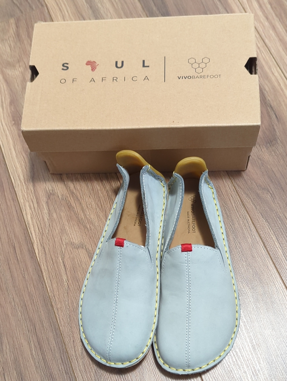Vivo Barefoot Light Gray Kids Slip-On Loafers with Yellow Stitching and Red Tabs